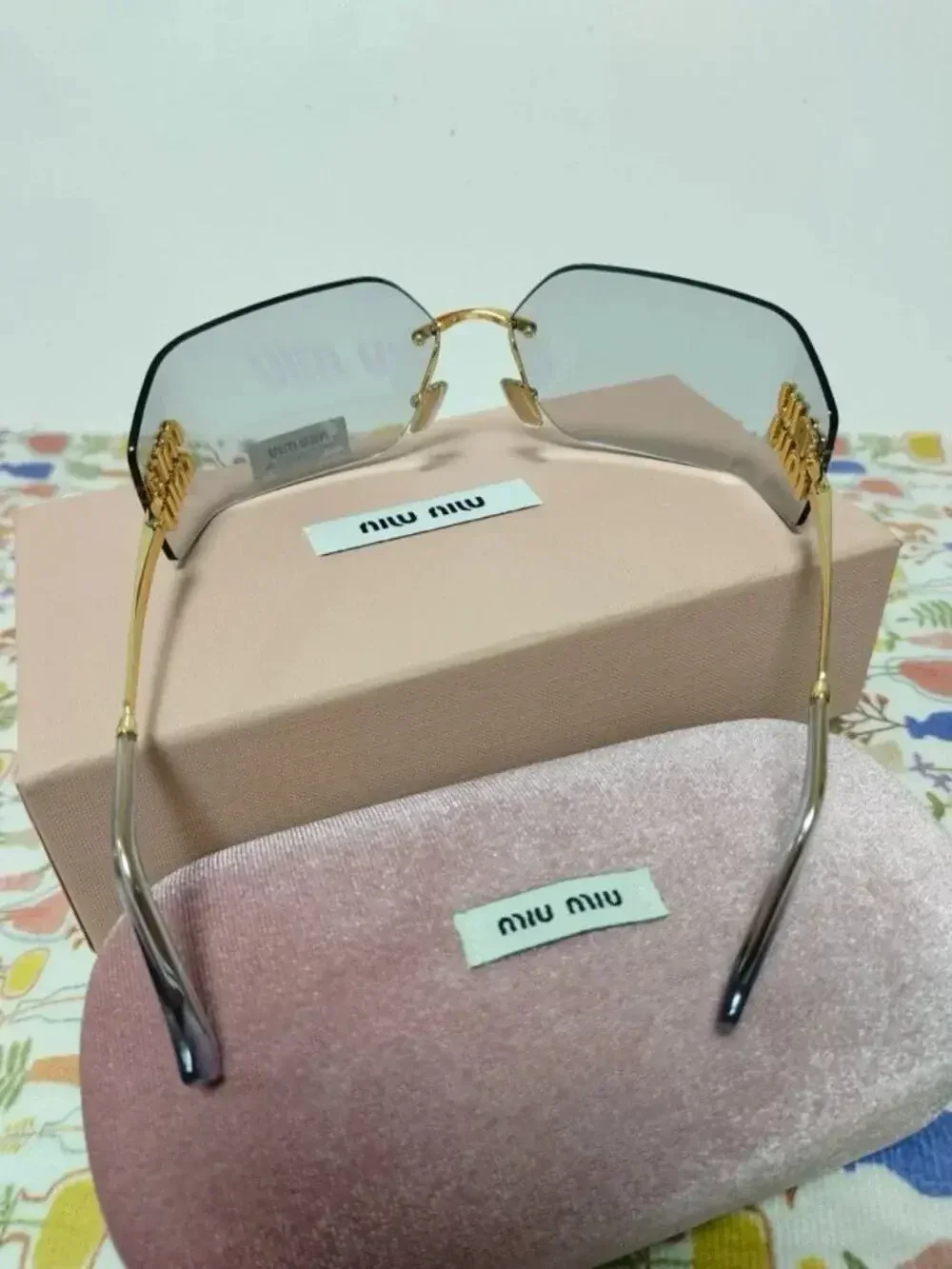 Miu Miu Rimless Grey Sunglasses with Oversized Gold Logo